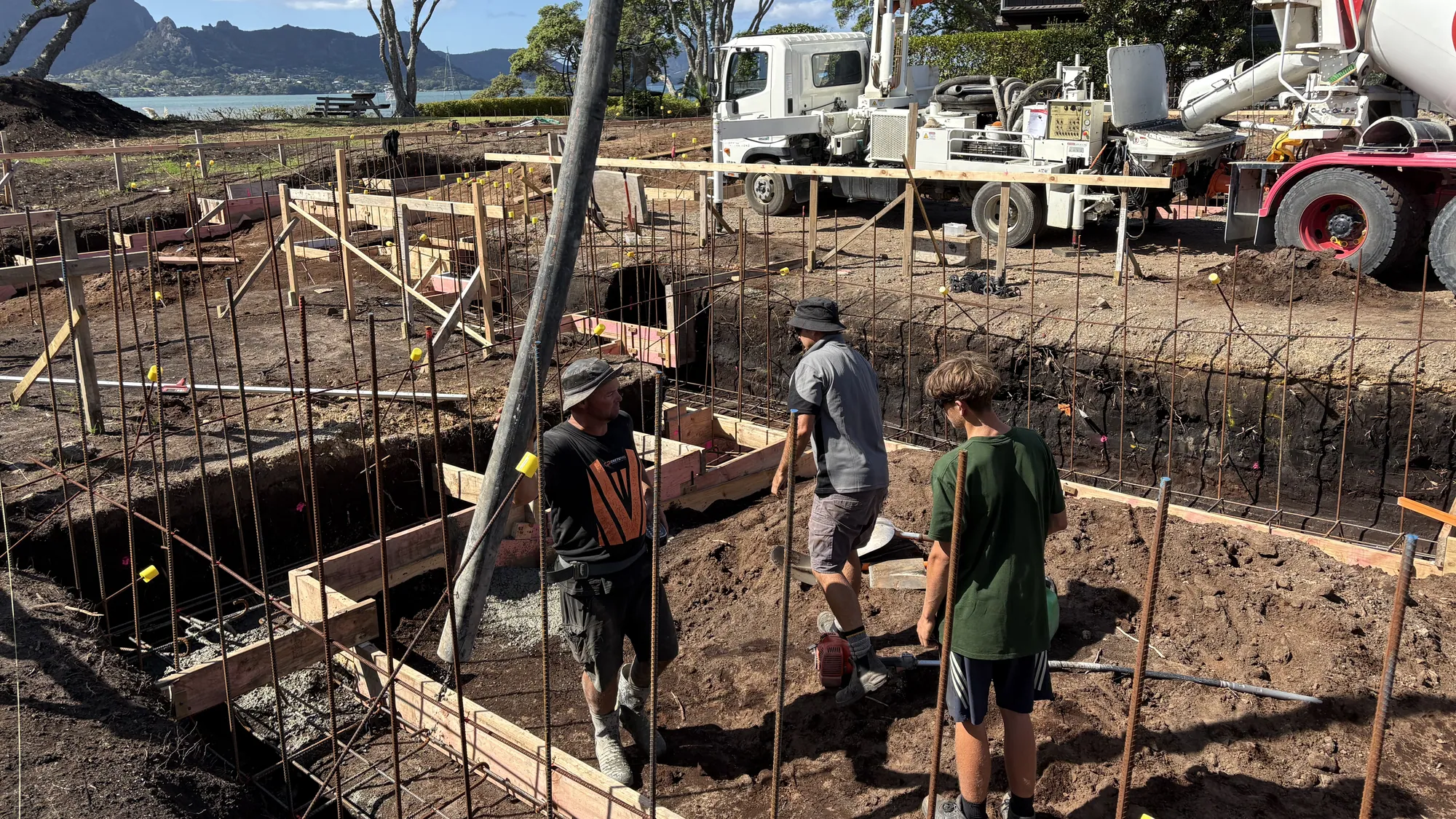 Foundations being poured on a Cogan build, with Whangarei Heads behind