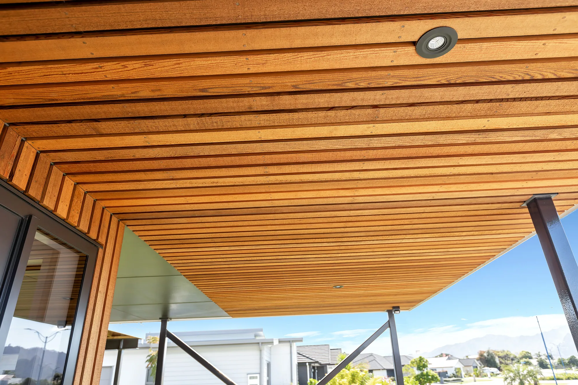 Dry-stacked schist against vertical cedar on a Cogan build