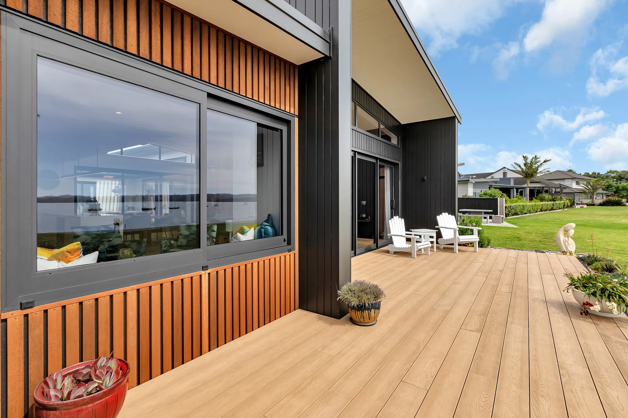Dark-clad home with cedar detail and a wide timber deck