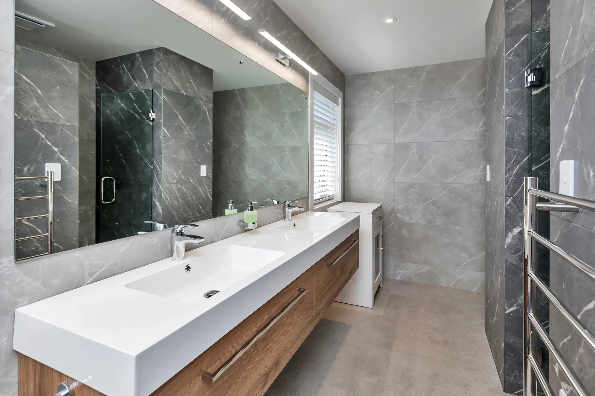 Bathroom with a long timber vanity and stone-look tiles