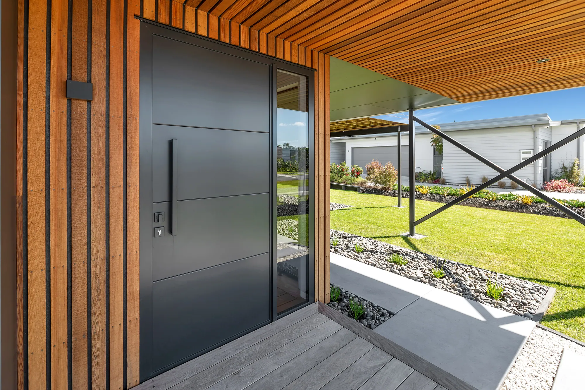 Cedar-battened entry with a solid pivot door