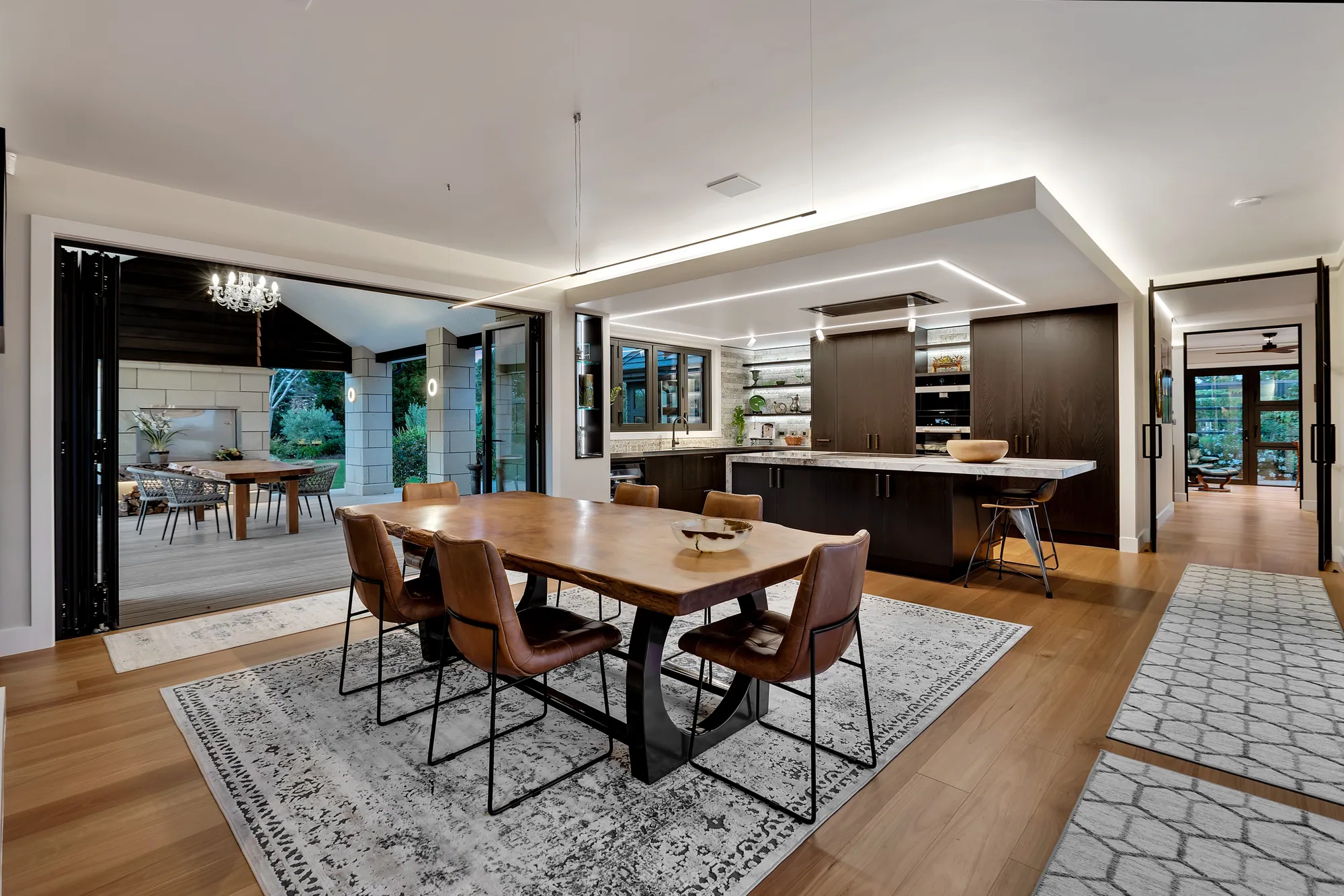 Open-plan dining, kitchen and living with timber floors