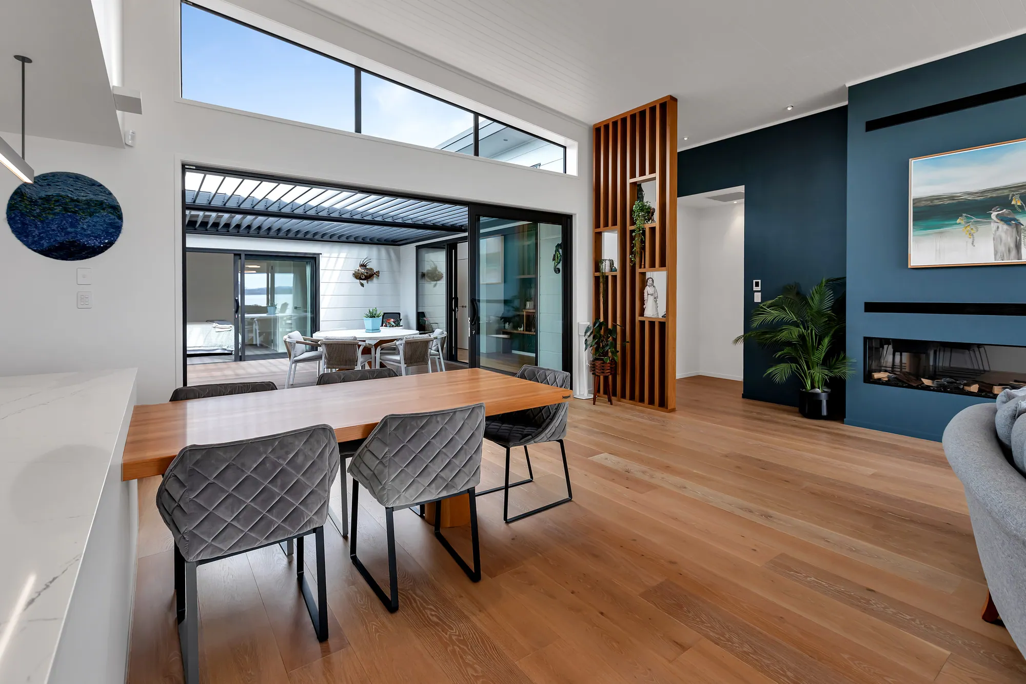 Dining table in front of a feature wall with a gas fireplace