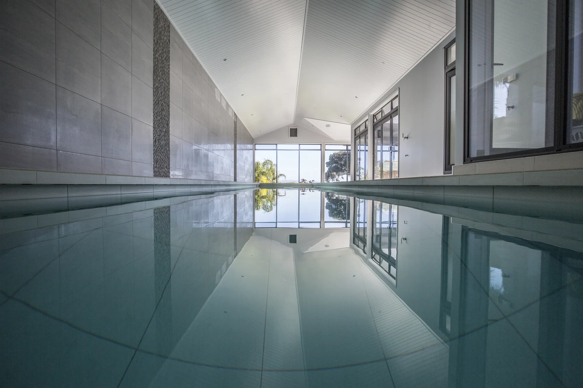 Indoor lap pool with full-height glazing