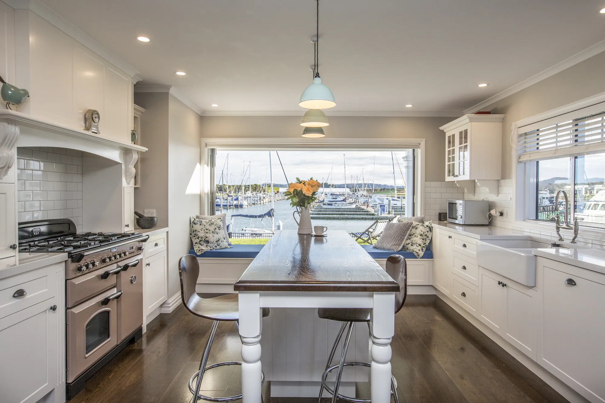 Country-style kitchen with a range cooker and marina view