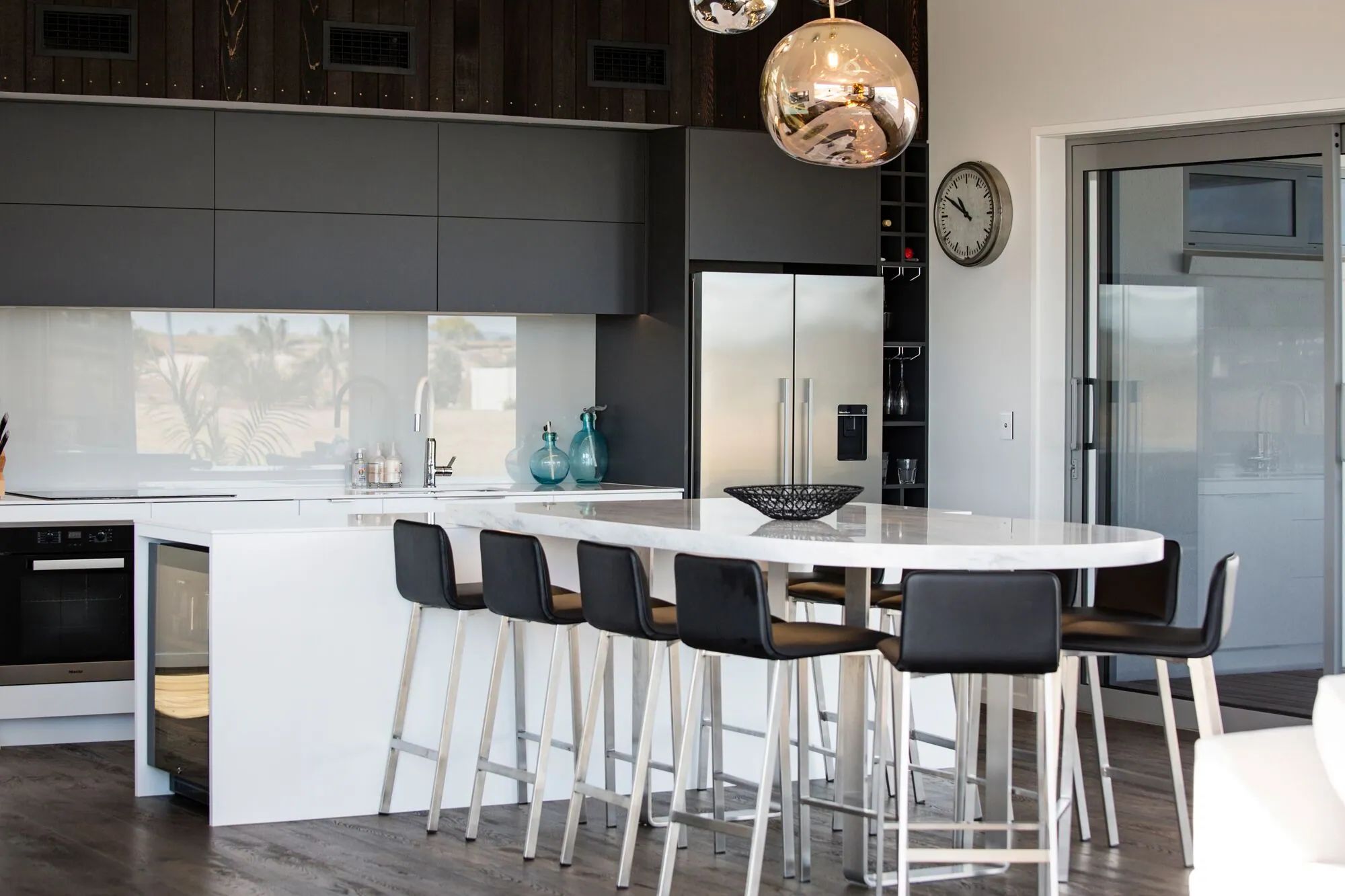 Kitchen with a curved breakfast bar and pendant lights