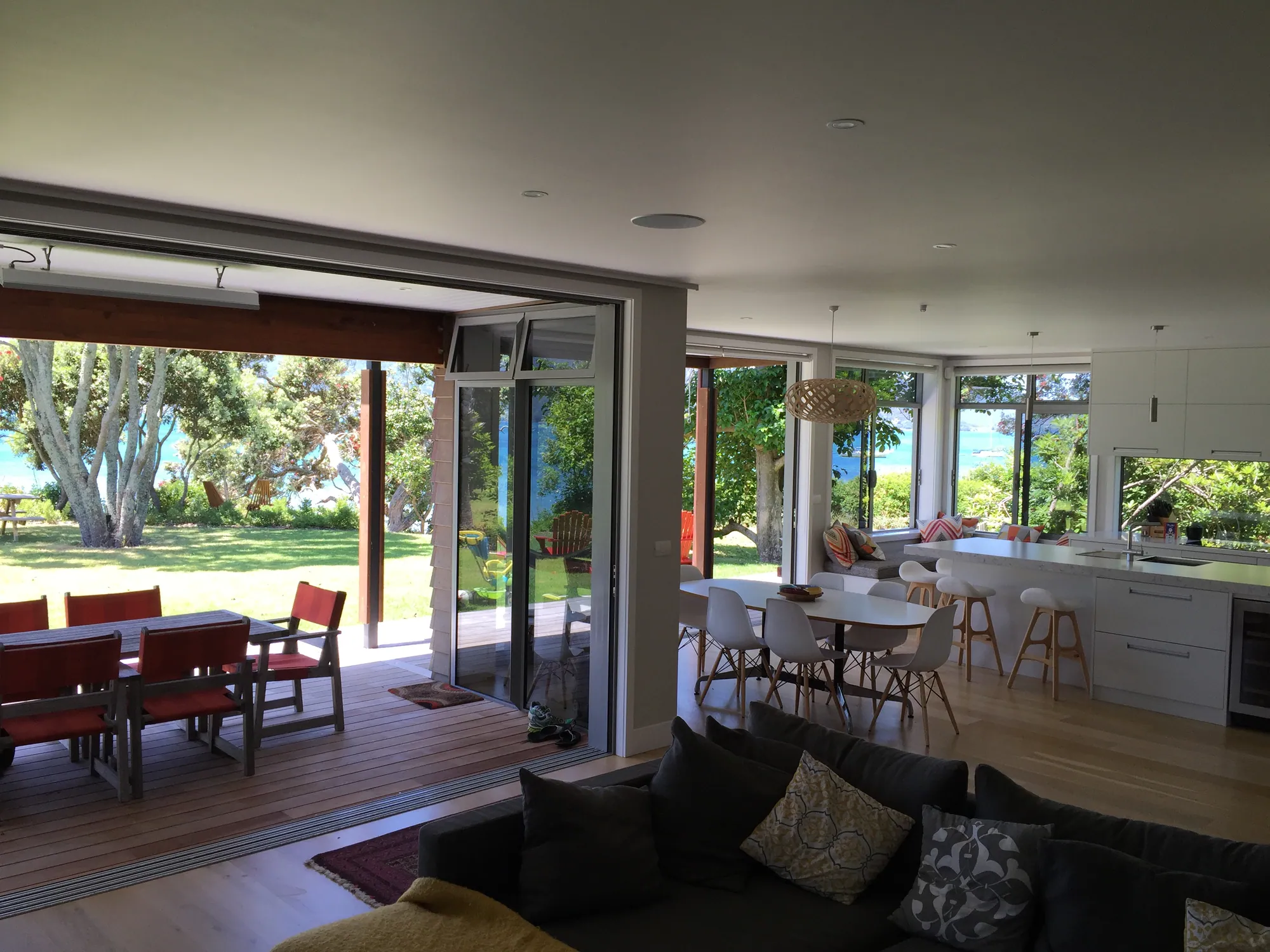 Living and dining opening to a covered deck and garden