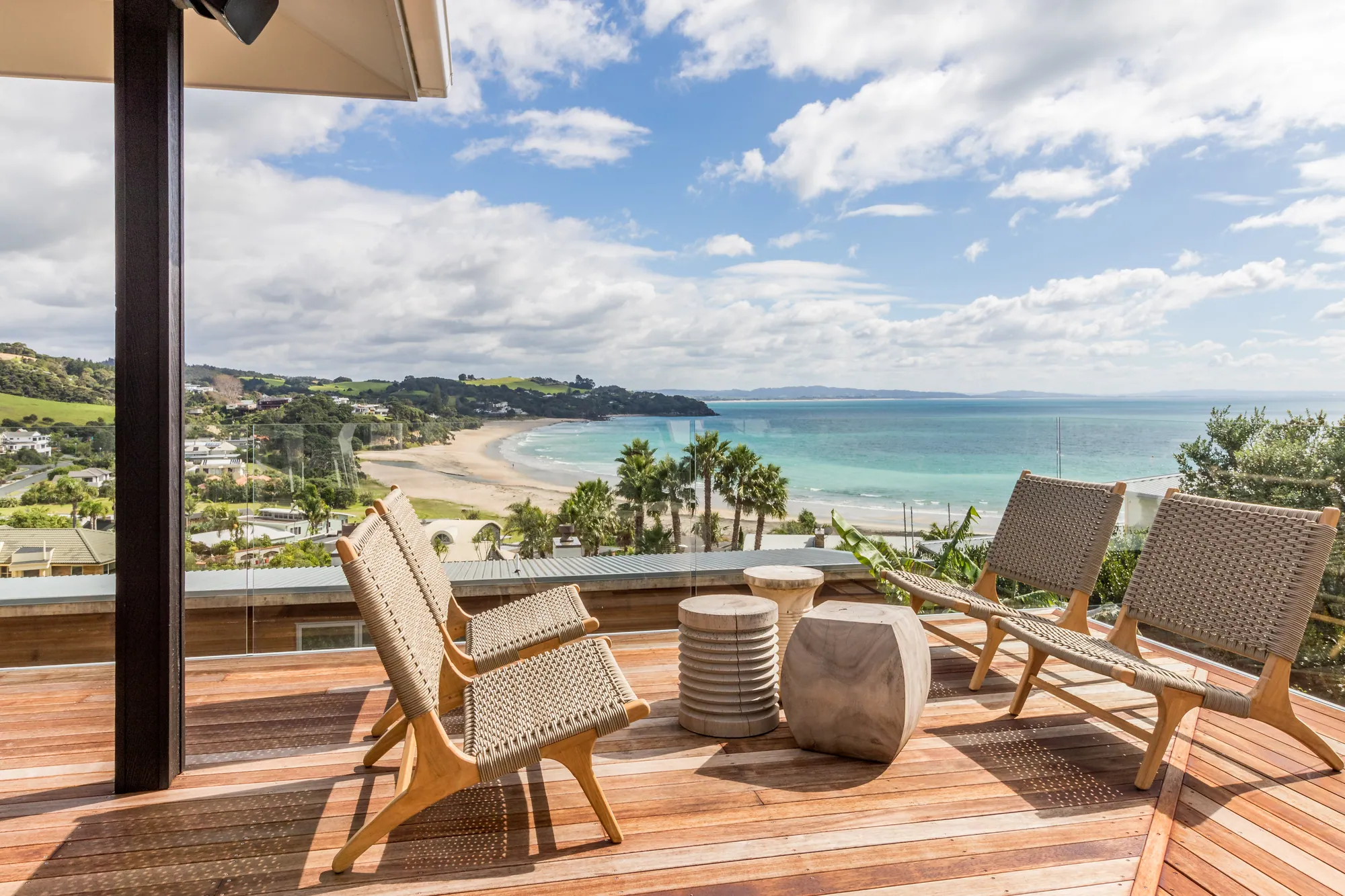 Deck with outdoor chairs above the beach and coastline