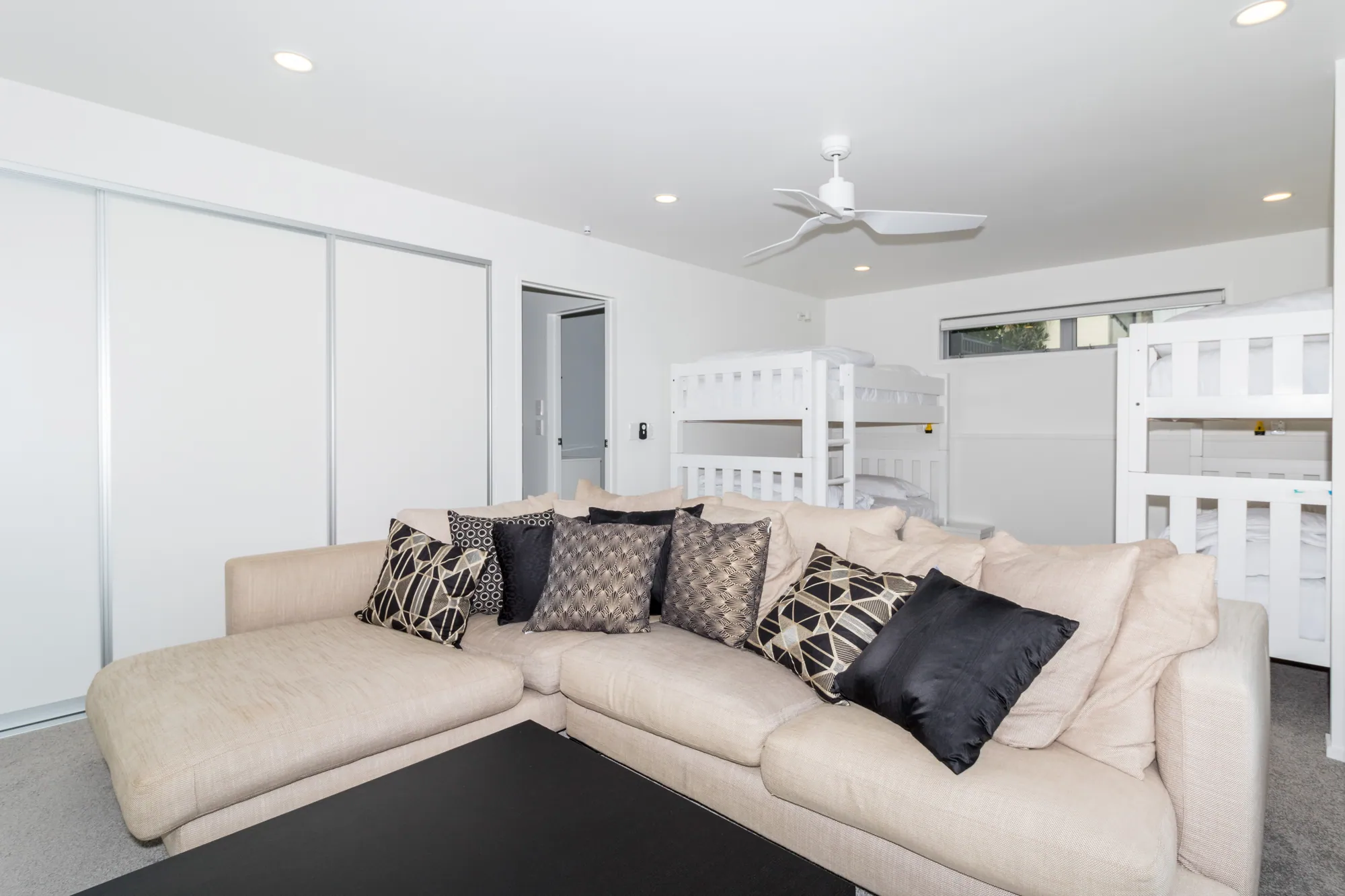 Downstairs living room and bunk room in a renovated beach house