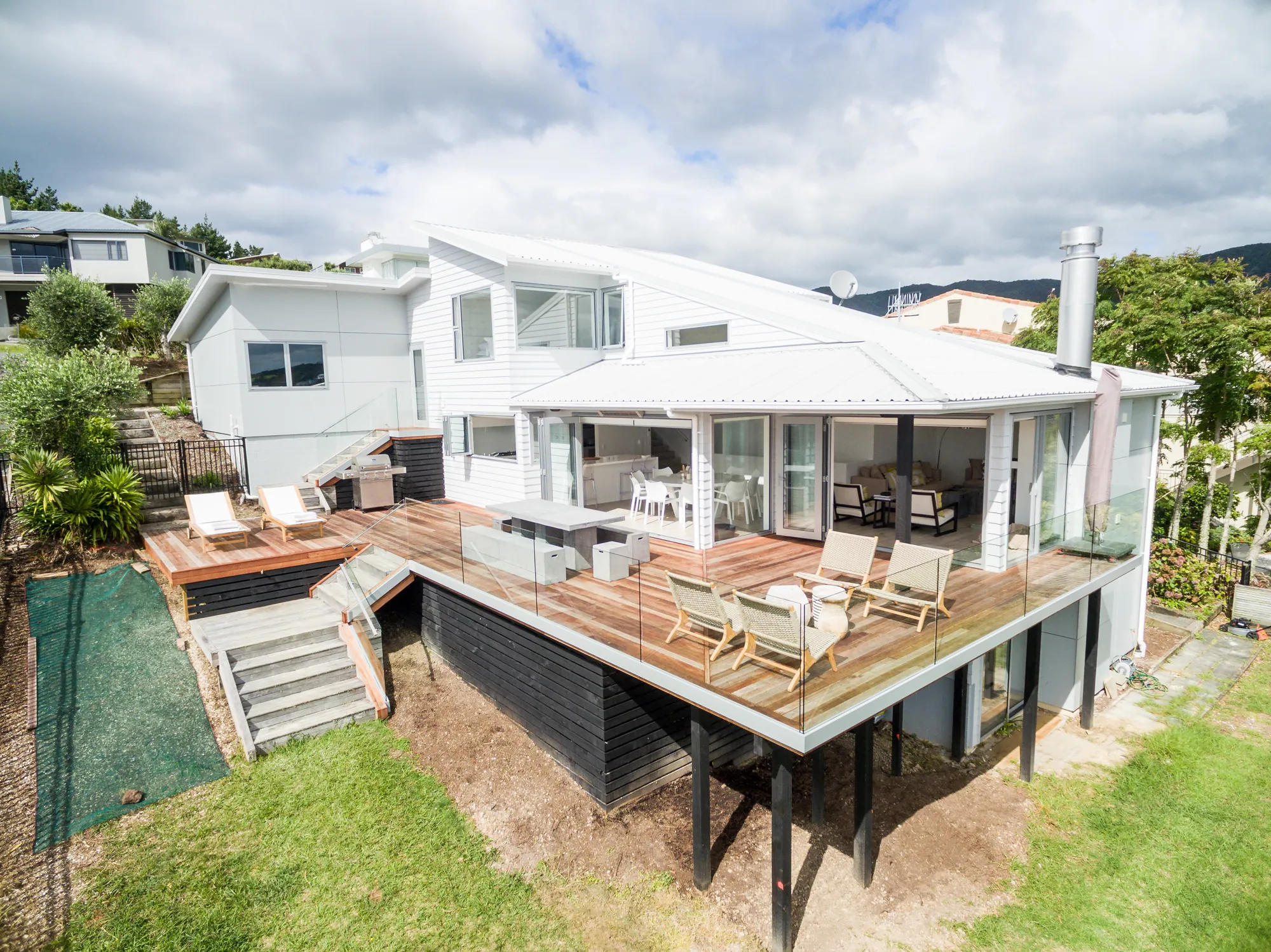 Renovated beach house with a large deck above the section