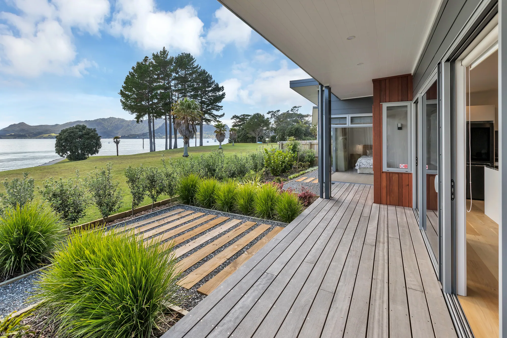 Timber deck running along a home toward the harbour