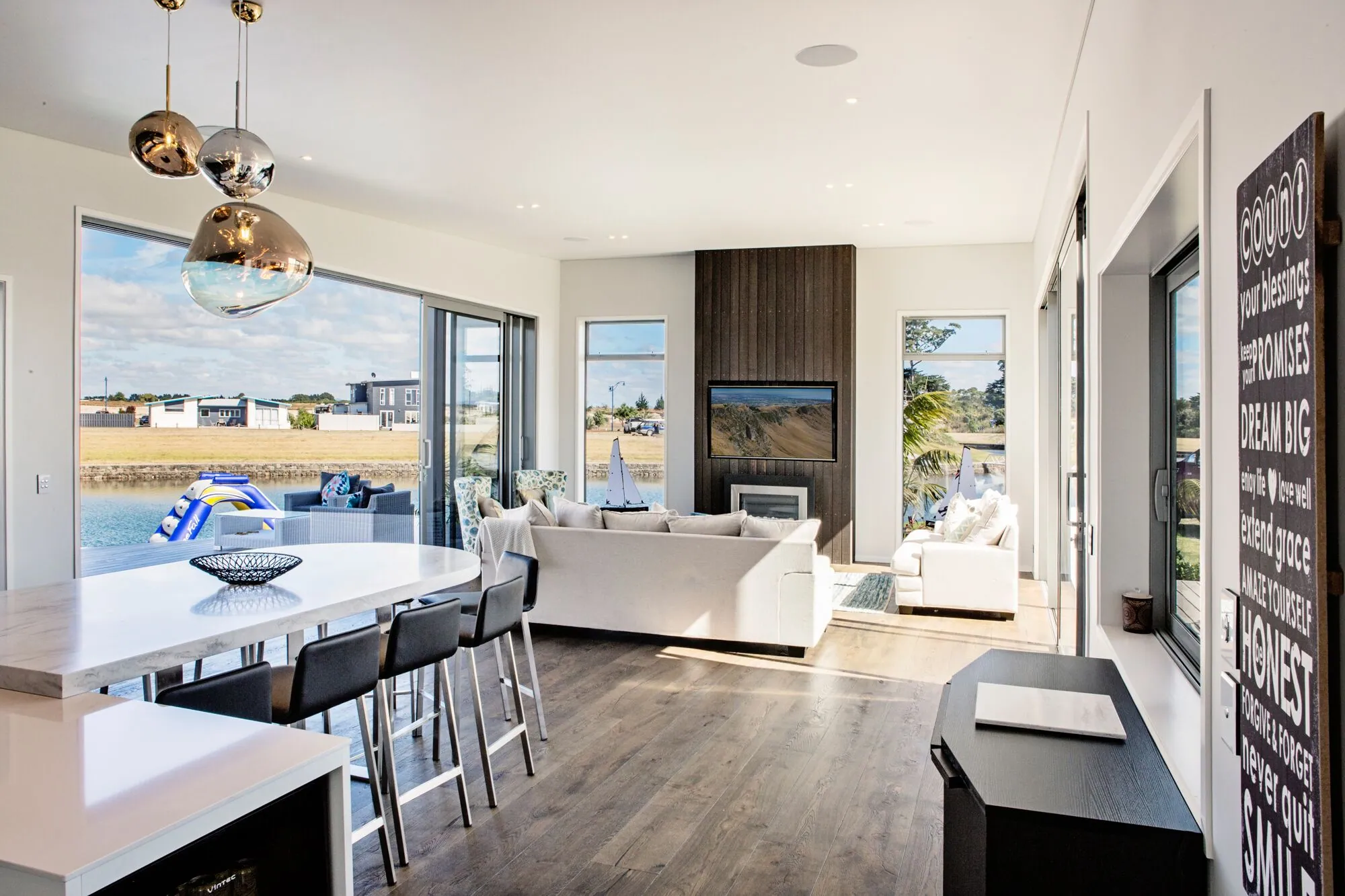 Kitchen and living room with the canal and a moored boat outside