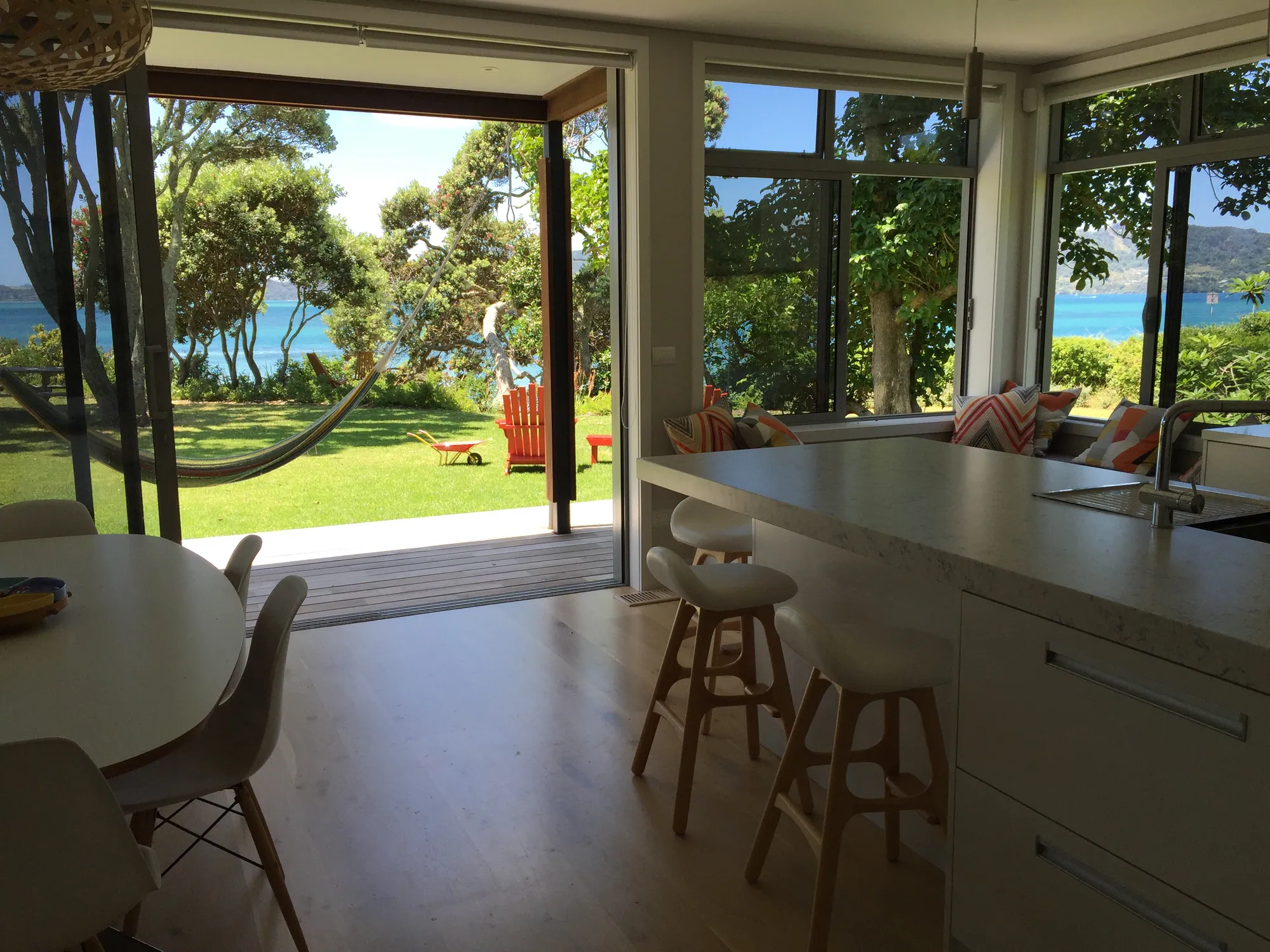 Kitchen and dining opening to the garden and the water
