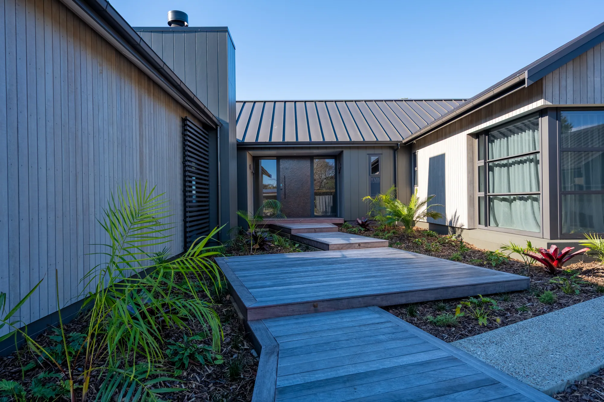 The entry path and planted approach to a completed Cogan home