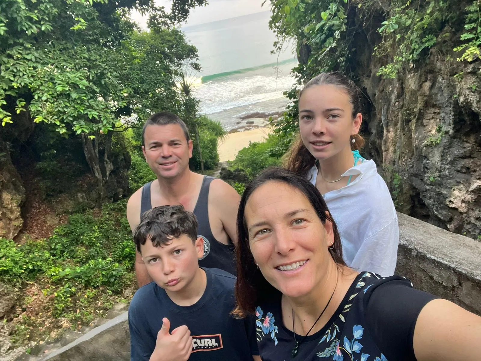 Simon Mansell with his wife and two children, above a beach